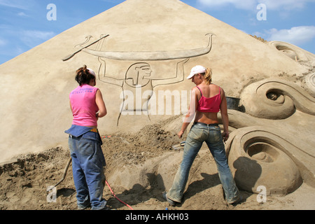 Artists at work at the world sand sculpting festival on Brighton beach in the south of England Stock Photo