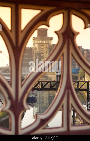 Sunrise on Royal Armouries National Museum shot through cast iron Crown Point Bridge River Aire Leeds Liverpool Canal UK Stock Photo