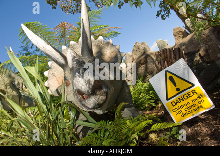 triceratops model Dinosaurs at warning sign  at Dan yr Ogof national showcaves of Wales Brecon Beacons National Park Powys Wales Stock Photo