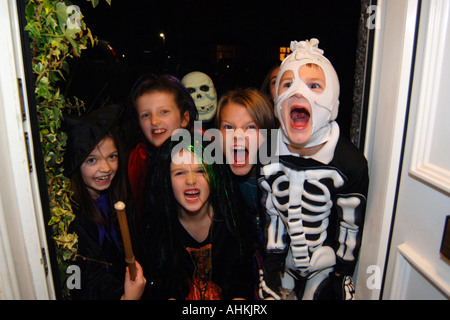 Halloween Trick or Treat children knock on doors asking for sweets or else a trick will be played on the householder Stock Photo