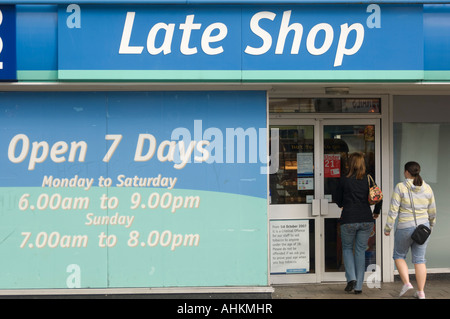 two women walking into a Co OP late shop  convenience food store open 7 days a weekWrexham Flintshire north wales UK Stock Photo