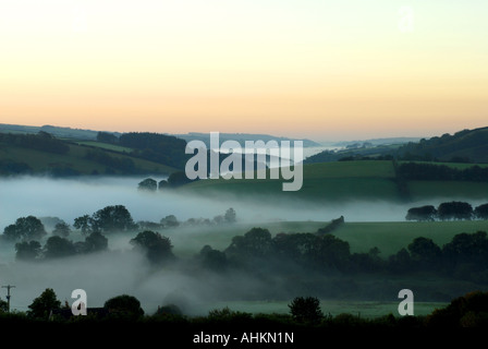 Dawn breaks over the mist filled valleys of Exmoor near Dunkery Beacon Stock Photo