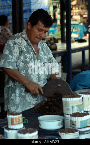Hand rolling mapacho tobacco in Belen Iquitos peru Stock Photo