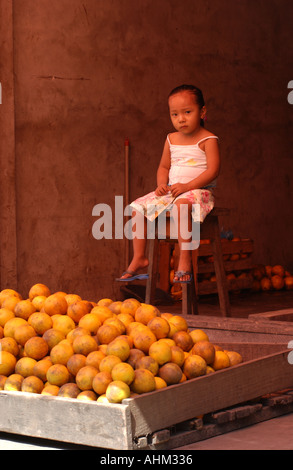 young girl selling potatoes in Belen Iquitos peru Stock Photo