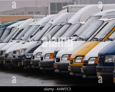 A row of white and coloured used Mercedes vans for sale Stock Photo
