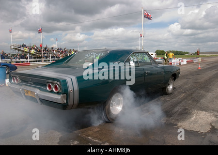 American muscle car doing burnout before start of drag race Stock Photo