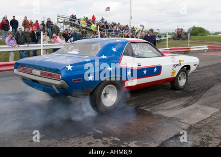 American muscle car doing burnout before start of drag race Stock Photo