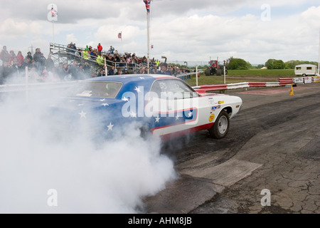 American muscle car doing burnout before start of drag race Stock Photo