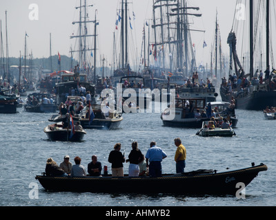 Spectators in their boat watching the Sail Amsterdam 2005 tall ship event parade the Netherlands Stock Photo