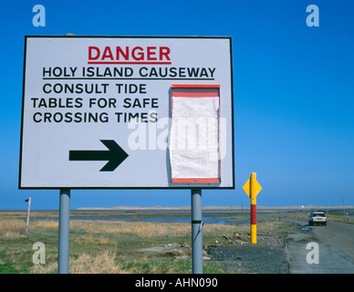 Tide timetables at the road causeway to Holy Island (Lindisfarne), Northumberland, England, UK. Stock Photo