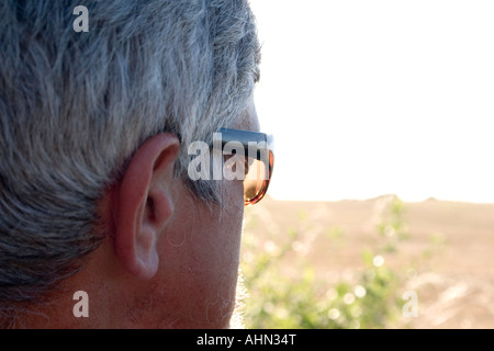 Man with sun glasses looking into distance Stock Photo