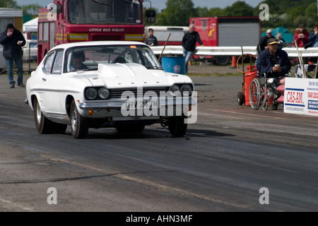 Heavily modified Ford Capri leaving startline at drag race Stock Photo