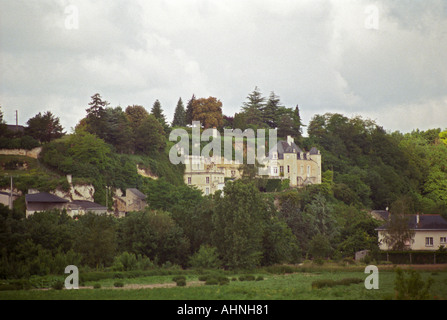 Chateau de Targe of Edouard Pisani in Saumur Champigny. The chateau is partially built in the rock using old lime stone quarry in troglodyte style under threatening rain clouds, Maine et Loire France Stock Photo