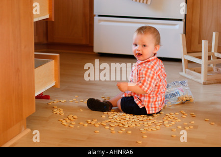 One year old boy getting into mischief Stock Photo