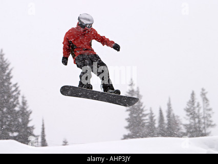 Snowboard rider in mid-air jump Stock Photo