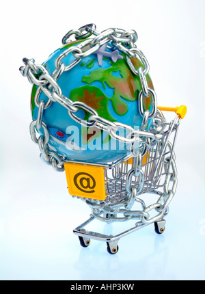 An empty shopping cart with @ on it and a globe chained to it Stock Photo
