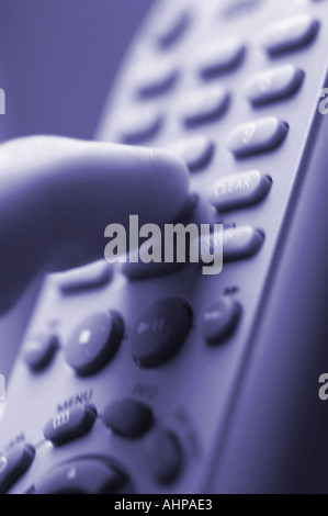 finger pushing buttons on a remote control Stock Photo