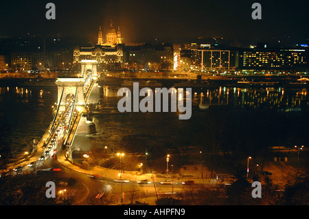 Horizontal wide angle aerial view of the River Danube and the Chain Bridge lit up at night.