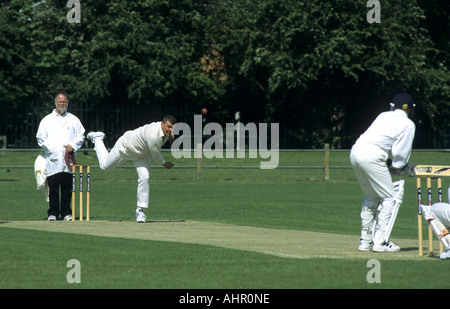 Bowler in action during village cricket match at Wellesbourne, Warwickshire, England, UK Stock Photo