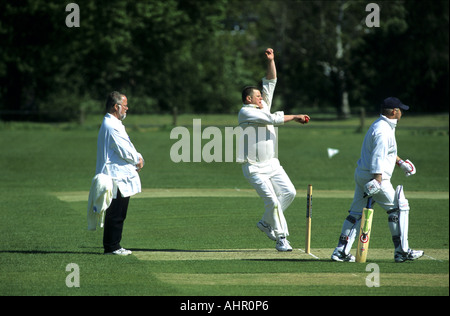 Man bowling during village cricket match at Wellesbourne, Warwickshire, England, UK Stock Photo