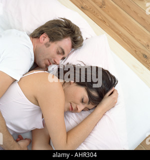 Close couple in bed asleep Stock Photo
