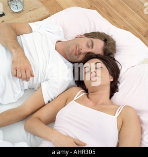 Close couple asleep in bed Stock Photo