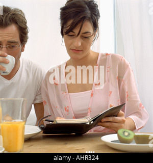 Couple with diary at breakfast