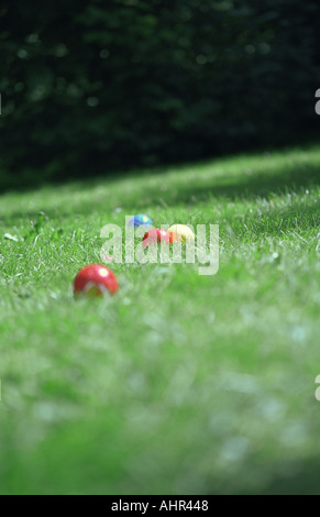 Coloured plastic balls in grass. Stock Photo