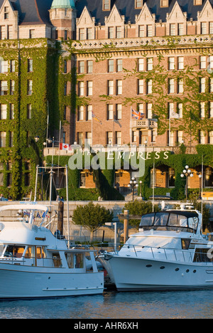 The Empress hotel and boats moored in Victoria BC s Inner harbour Stock Photo