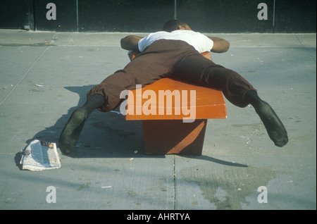 Homeless black man sleeping on a park bench New York City New York ...