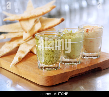 crusty flatbread with three dips Stock Photo