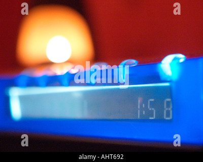 Digital clock and candle Stock Photo