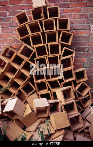 Pile of wooden boxes against red brick wall Stock Photo