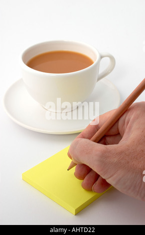 writing a post it note Stock Photo