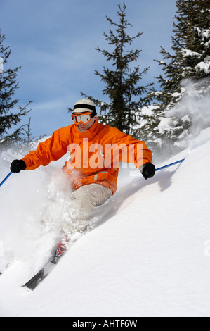 Austria, Saalbach, male skier turning in snow on slope Stock Photo