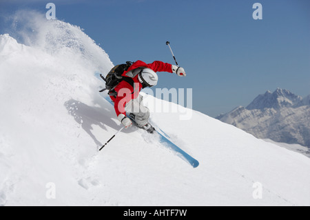 Austria, Saalbach, man skiing down mountain slope Stock Photo