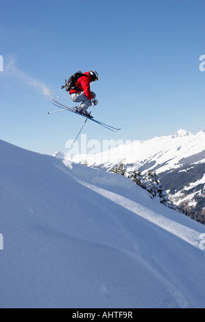 Austria, Saalbach, male skier jumping down slope Stock Photo