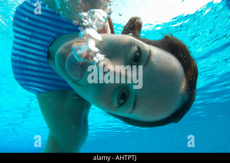 Female swimmer pulling face, portrait, underwater view Stock Photo