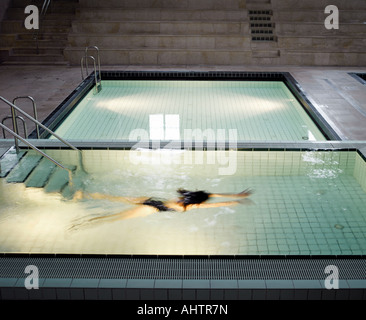 Woman swimming under water in outdoor swimming pool Stock Photo - Alamy