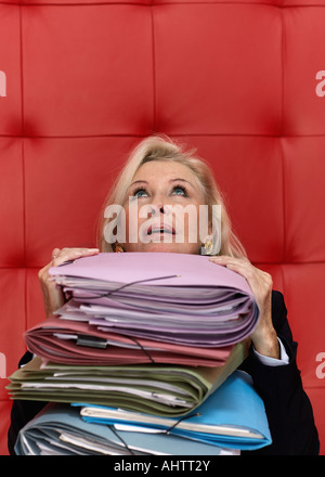 Businesswoman working at a table with red seating Stock Photo