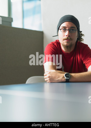 Young man sitting at desk portrait Stock Photo