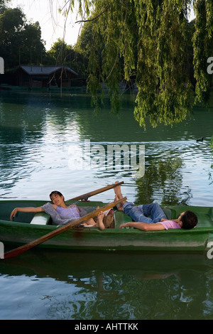 Man and woman lying down in a boat Stock Photo