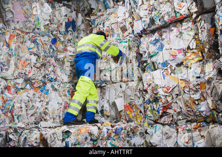 Man leaning on wall of recycling. Stock Photo