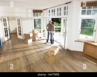 Couple moving boxes into new house. Stock Photo