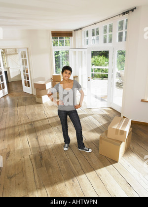 Woman moving in empty house. Stock Photo