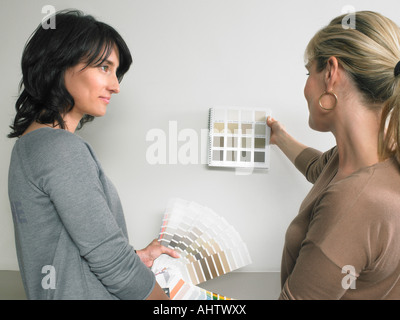 Female interior designer showing samples of color to client. Stock Photo