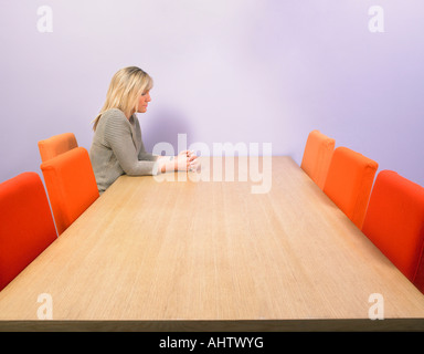 Pensive businesswoman at meeting table. Stock Photo