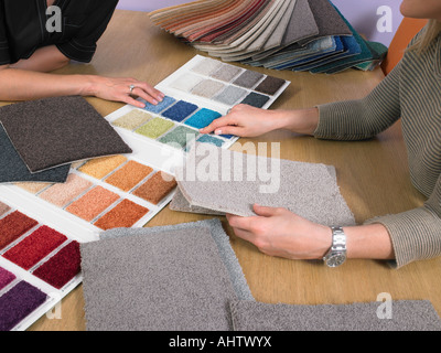 Designer showing carpet samples to client. Stock Photo