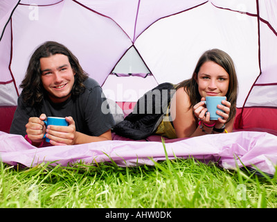 Couple with mugs in pink tent Stock Photo