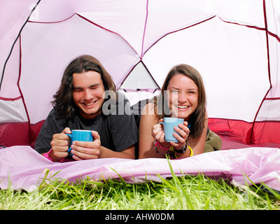 Couple with mugs in pink tent Stock Photo